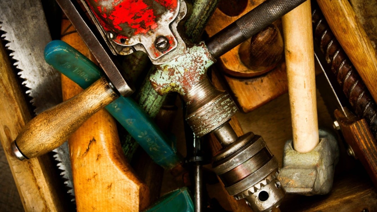 worker-hands-holds-detail-lathe-on-background-GYT5